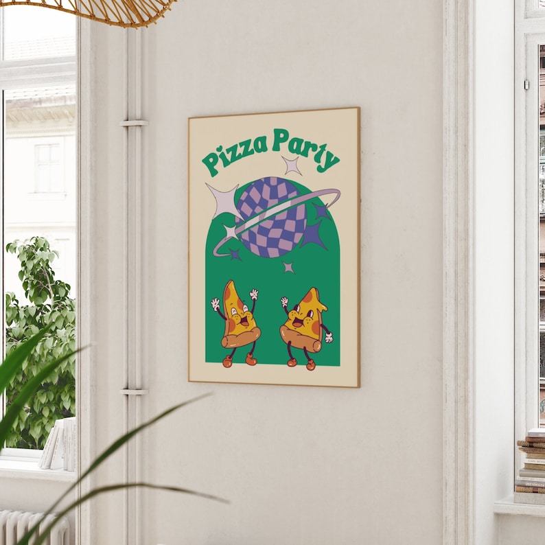 May include: A framed poster with the words "Pizza Party" in green lettering. The poster features a cartoon illustration of two pizza slices with smiling faces, a planet with a checkered pattern, and stars, all in a retro style.