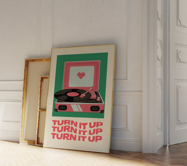 May include: A vintage-style record player with a pink body and a green background. The record player has a heart-shaped design on the front and the text "TURN IT UP" repeated three times.