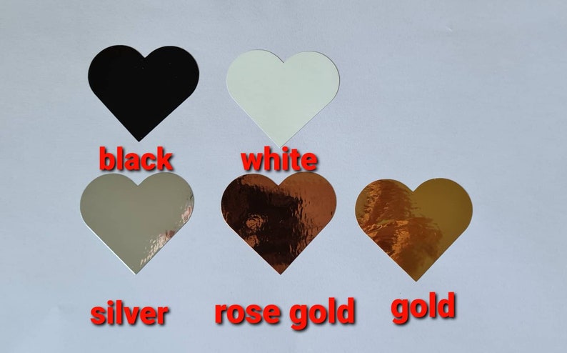 May include: Five heart-shaped stickers in different colours: black, white, silver, rose gold, and gold.