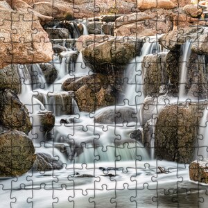 Waterfall Print wall art instant download of a soft waterfall gently flowing over the rocks in a mockup of the image printed on a puzzle.