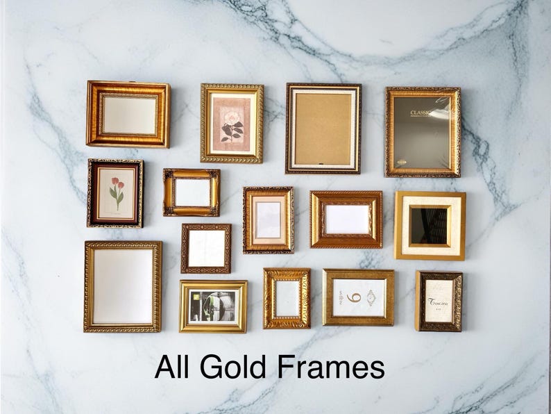 May include: An assortment of gold picture frames in different shapes and sizes, displayed on a marble-effect wall. Some frames contain artwork or mirrors. The text "All Gold Frames" is visible at the bottom of the image.