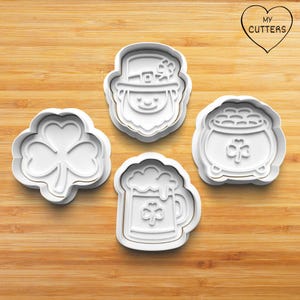 May include: A white ceramic mug with a black handle and the text "But First, Coffee" in a black, bold font. The mug is on a wooden surface. The mug is approximately 10 cm tall.