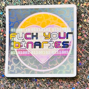 May include: Square sticker with a holographic background and a heart-shaped design. The sticker features the text "FUCK YOUR BINARIES" in a colorful, bold font. The background includes binary code and heart shapes.