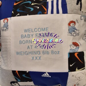 May include: A square patchwork memory cushion featuring various fabric patterns including blue, black, and white sections. The centre white panel displays the text: WELCOME BABY FEAM BORN AT 4:16 WEIGHING 6lb 8oz XXX. Includes logos for Nike and Adidas.