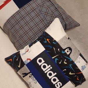 May include: Two square scatter cushions constructed from various fabric patches. One cushion features a blue Tottenham Hotspur logo, while the other displays a prominent white adidas logo on a blue background, surrounded by patterned fabric panels.