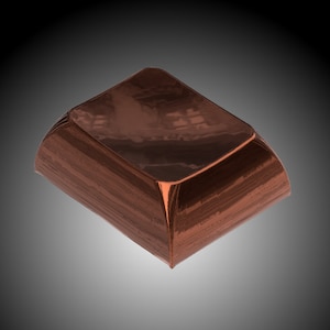 May include: A copper-colored, rectangular box with a curved top and sides. The box has a shiny, reflective surface, and the edges are slightly rounded. The overall design is minimalist and modern, with a focus on clean lines and a polished finish.