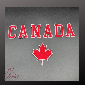 May include: Embroidered patches in red and white spelling "CANADA" with a red maple leaf emblem. The patches have a white border and are set against a dark grey background. The image also includes a signature.