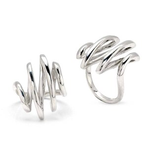 May include: Two silver rings with a unique, abstract design. The rings are made of twisted, curved lines that create a modern and stylish look.
