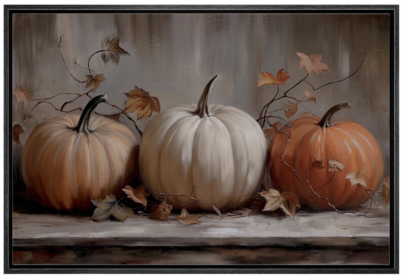 May include: A framed painting featuring three pumpkins in varying shades of orange and white. The pumpkins are arranged on a wooden surface, with dried leaves and vines adding autumnal detail. The background is a muted, neutral tone.