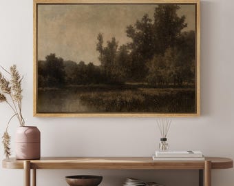 May include: A framed landscape painting depicting a forest scene with a river in the foreground. The painting is in muted tones of brown and green, with a soft, hazy sky.