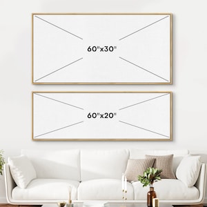 May include: Two rectangular canvas art pieces with gold frames are displayed on a white wall. The top canvas is labeled "60"x30"" and the bottom canvas is labeled "60"x20"". A white sofa with decorative pillows and a vase of greenery is in front of the wall.
