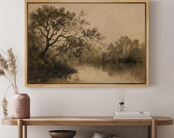 May include: A framed sepia-toned landscape painting depicting a large tree with branches reaching over a still body of water. The painting has a rustic, vintage aesthetic.