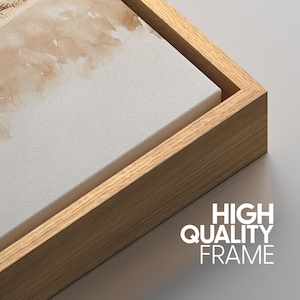 May include: Close-up of a wooden frame surrounding a canvas print. The frame is a light brown color and has a smooth finish. The canvas is white with a subtle texture. The text "HIGH QUALITY FRAME" is printed in white on a gray background below the frame.