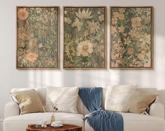 May include: A set of three framed floral prints with a vintage aesthetic. Each print features a different arrangement of flowers in shades of pink, white, and green, with a textured background.