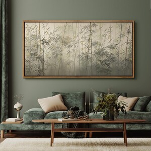 May include: A green velvet sofa with two pillows and a wooden coffee table in front of it. A framed painting of a bamboo forest hangs on the wall behind the sofa.