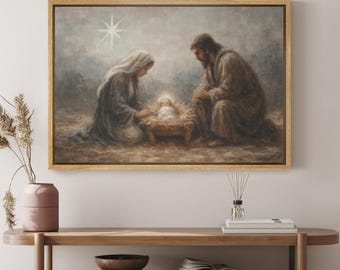 May include: A framed painting depicts the Nativity scene. Mary and Joseph kneel beside the baby Jesus in a manger. A bright star shines above them. The artwork is in muted tones of brown, blue, and white, with a gold frame.