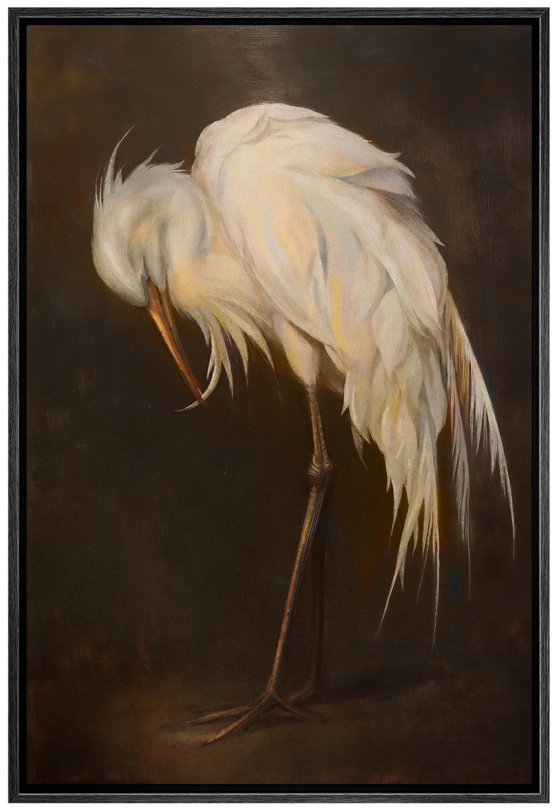 May include: A framed painting depicting a white egret with its head bowed, revealing its long beak and fine feathers. The bird stands on slender legs against a dark brown backdrop, creating a tranquil and elegant artwork.