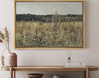 May include: A framed painting depicting a field of wildflowers in shades of green, white, and blue. The field is in the foreground, with a line of trees in the background. The sky is a light blue with a few clouds.