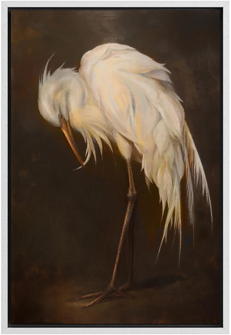 May include: Oil painting of a white egret with its head tucked down, showing detailed feather textures. The bird's long legs and beak are visible against a dark brown background, framed in a white border.