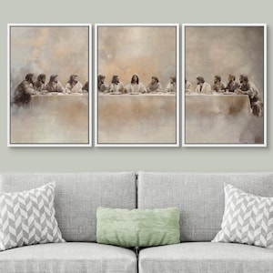 May include: A triptych canvas art print of the Last Supper. The artwork features a neutral colour palette with figures seated at a long table. Each framed panel is displayed above a grey sofa with decorative cushions.