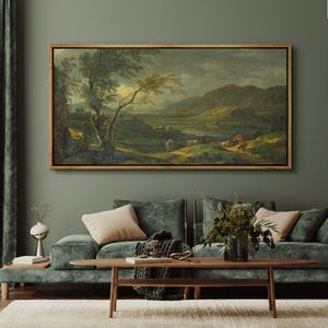 May include: A framed landscape painting with a wooden frame. The artwork depicts a pastoral scene with figures, trees, and rolling hills. The color palette includes greens, browns, and blues, creating a serene atmosphere. The painting is displayed above a green sofa.