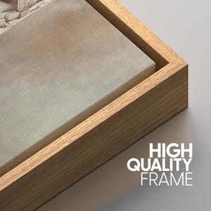 May include: A canvas print in a light-coloured wooden frame. The canvas has a light beige colour. The text "HIGH QUALITY FRAME" is printed in white on the bottom right corner.