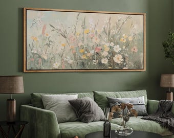 May include: A framed canvas print of a watercolor painting depicting a field of wildflowers in shades of pink, yellow, and white. The flowers are arranged in a loose, natural style, and the background is a soft green.