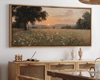 May include: A rectangular landscape wall art print featuring a sunset over a field of white daisies and a large tree. The scene includes rolling hills in the distance under a soft orange sky, with small glowing light points scattered across the meadow.
