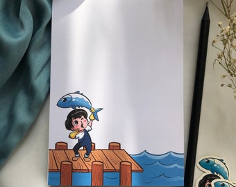 May include: A cartoon illustration of a person holding a blue fish on a wooden dock over blue water. The person is wearing blue overalls and yellow gloves.