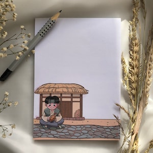 Könnte beinhalten: Eine Cartoon-Illustration einer Person, die auf einem Steinweg vor einem kleinen Haus mit Strohdach sitzt. Die Person hält einen kleinen braunen Vogel in ihren Händen. Das Haus hat eine Holztür und Fenster.