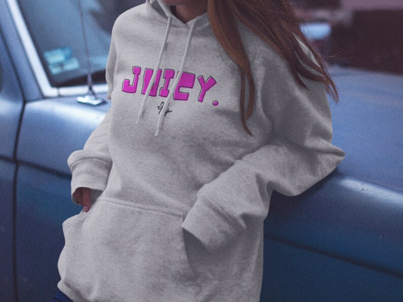 May include: A gray hooded sweatshirt with the word "JUICY" printed in pink letters on the front.