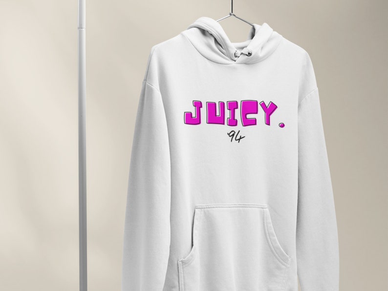 May include: White hoodie with a pink "JUICY." logo and "94" written underneath.