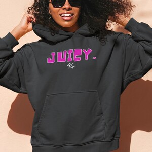 May include: Black hoodie with a pink "JUICY. 94" graphic on the front.