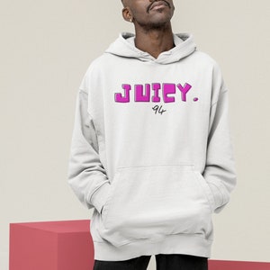 May include: A white hoodie with a pink "JUICY. 94" graphic print.