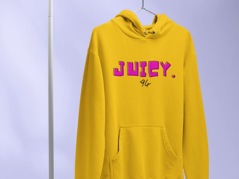 May include: A yellow hoodie with a pink "JUICY." logo and the number "94" written underneath.