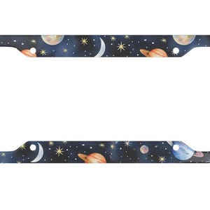 May include: A license plate frame featuring a dark blue background adorned with a repeating pattern of planets, stars, and crescent moons. The planets are in orange, blue, and beige. The stars are yellow.
