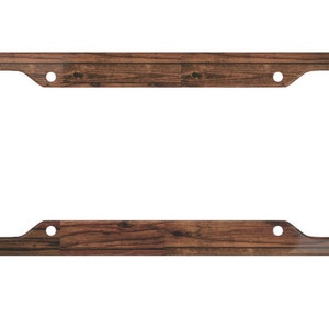 May include: A brown woodgrain license plate frame with rounded corners and four holes for mounting.