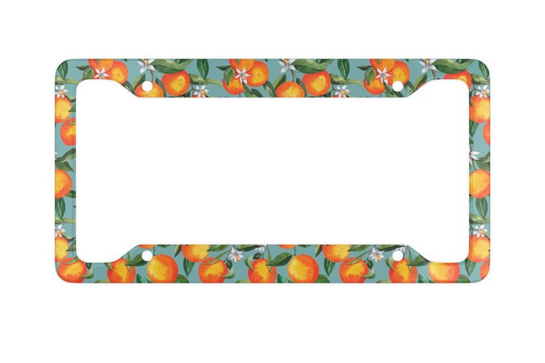 May include: License plate frame with a teal background and a repeating pattern of orange citrus fruits, green leaves, and white blossoms. The frame has a rectangular shape with cutouts for the plate and mounting hardware.
