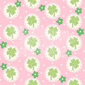 May include: A pink background with a repeating pattern of green four-leaf clovers in white circles with a white scalloped edge. Small white dots and green four-leaf clovers are scattered throughout the pattern.