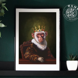 May include: A framed print of a monkey wearing a gold crown and a fur-trimmed robe. The monkey is sitting on a throne and has a serious expression on its face. The print is titled "Jungle Treasures" and has a home decor theme.