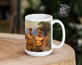 May include: White ceramic mug with a handle. The mug features a vintage illustration of two men standing in a landscape setting. The men are shirtless and wearing pants. The background is a colorful landscape with mountains and trees.