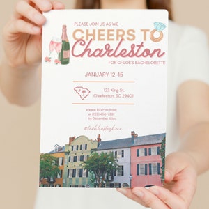 May include: A printed invitation with the text "Cheers to Charleston" for Chloe's bachelorette party. The invitation includes a watercolor illustration of Charleston buildings and details such as the date, location, and RSVP information.