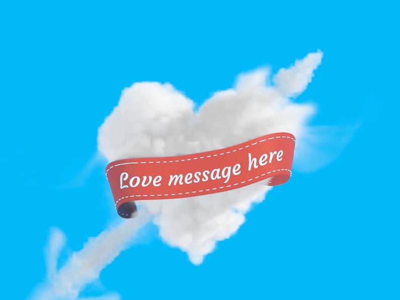 Puede incluir: Una nube blanca con forma de coraz&oacute;n con una cinta roja que dice "Love message here" sobre un cielo azul.