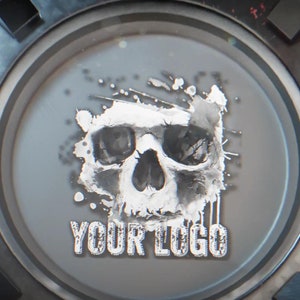 Può includere: Un grafico di teschio stilizzato con uno schema di colori bianco e grigio, su uno sfondo circolare metallico. Il testo "YOUR LOGO" è stampato sotto il teschio.