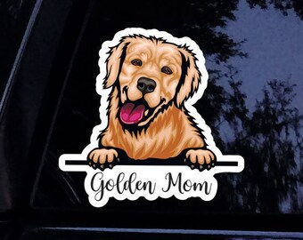 Peut inclure: Un autocollant représentant un chien golden retriever de dessin animé regardant par-dessus une bannière qui dit "Golden Mom".
