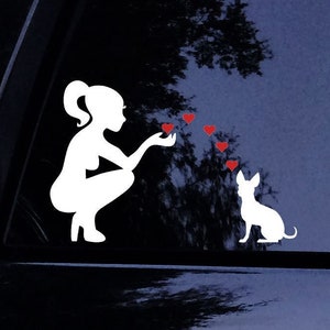 May include: White silhouette of a woman blowing hearts to a white silhouette of a chihuahua dog. The hearts are red.