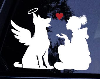May include: A white vinyl decal featuring a silhouette of a dog with angel wings and a halo sitting next to a silhouette of a person blowing a kiss toward the dog, with a small red heart graphic positioned between the two figures.
