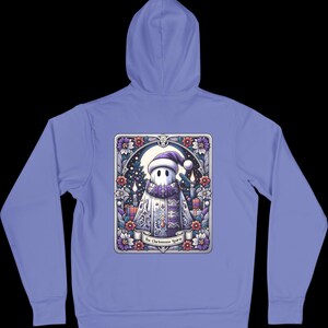 May include: A light blue hoodie with a graphic of a ghost wearing a Santa hat and holding a gift. The graphic is surrounded by a floral border and the text "The Christmas Spirit".