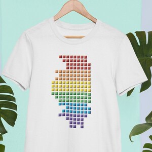May include: White t-shirt featuring a pixelated rainbow design.