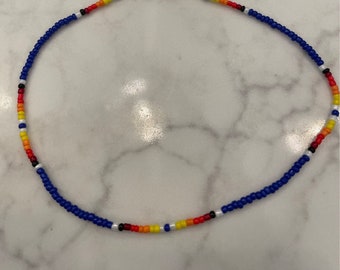 14” blue seed bead choker with segments of sunset colors and quartz closure